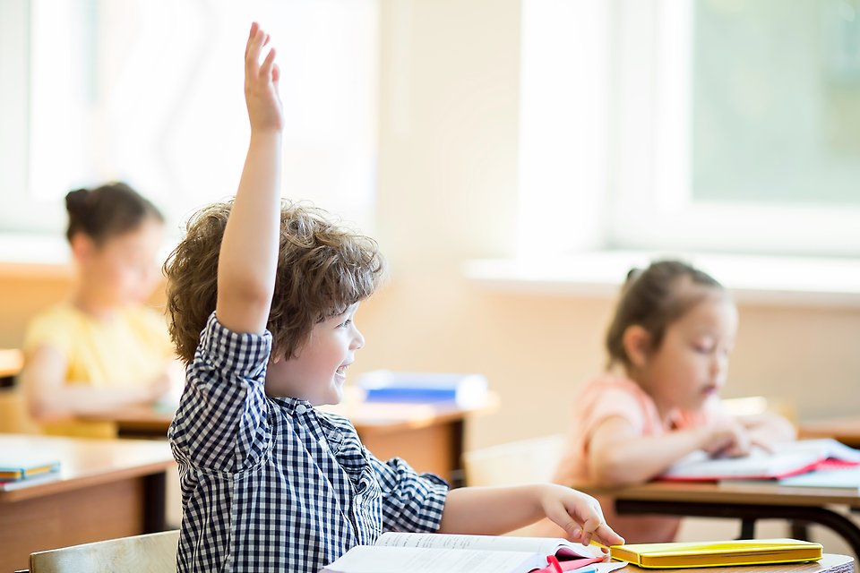 Child pupil in a classroom